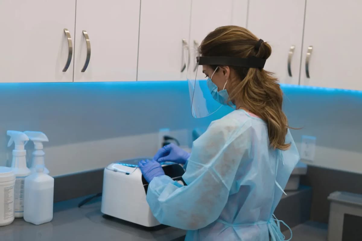 Young sterile processing technician cleaning medical supplies
